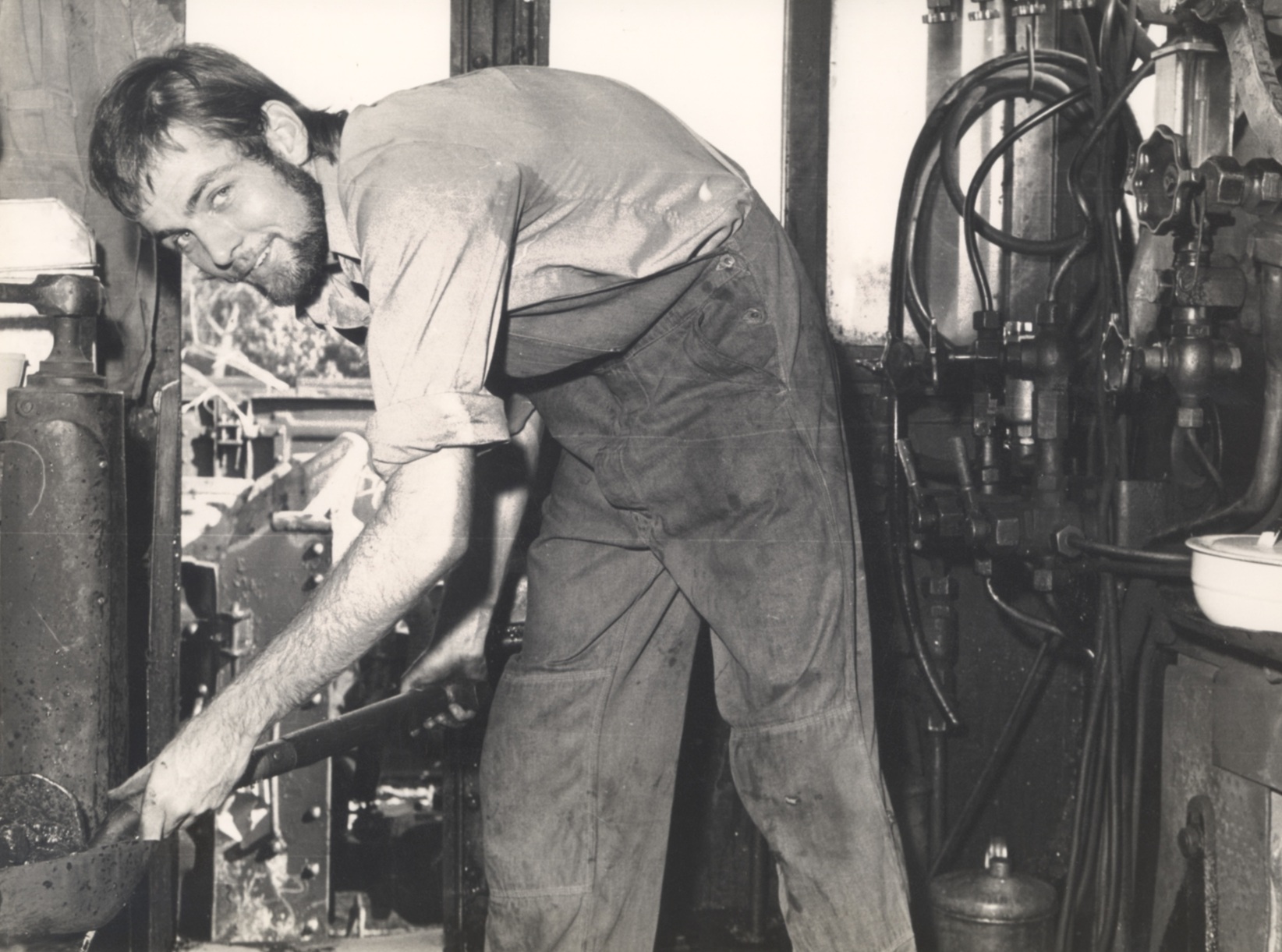John Queripel stoking a steam engine, JQA founder.